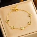 Elegant gold hollow camellia titanium steel bracelet showcased in a beige jewelry box - Single Piece (Bracelet) (B1385)