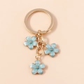 Portachiavi con fiori di ciliegio azzurro e anello in metallo dorato raffinato - Blu