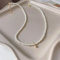 Elegant gold plated pearl necklace with a star moon pendant on a beige ceramic plate - 16# Necklace - White