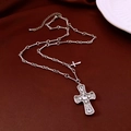 Close-up of silver cross pendant with clear crystals on dark red fabric background - Silver Rhinestone Cross Pendant