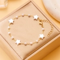 Golden ankle bracelet with white star charms and pearls on a brown jewelry box - White Five-pointed Star Pearl Style (BR24Y0239) / Gold