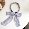 Lavender floral headband with twist design, pearl accents and bow detail on white surface - Purple Floral