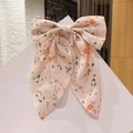 Pince à cheveux nœud à fleurs avec motifs orange sur base textile rose clair - Rose