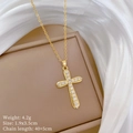 Detailed specs of gold cross necklace with clear crystals on white silk background - Gold Cross (D448)