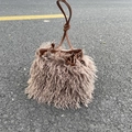 Detail of khaki faux sheepskin bucket bag with brown leather drawstring and knotted handle - Milk Tea