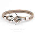 Close-up of beige milan line woven bracelet featuring a polished silver aircraft charm - Khaki Rope Silver Airplane
