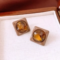 Detailed view of vintage square stud earrings with amber resin inlays on fabric - 30# Vintage Square Amber Studs (30#)