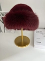 Chic burgundy faux fur winter hat on elegant display stand for luxury warmth - Angola Red