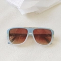 Détail de lunettes de soleil ovales dégradé bleu clair avec finitions dorées - Bleu Blanc