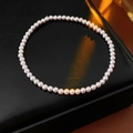 Macro shot of elegant round pink-white pearls on a textured black leather background - Pink 3mm Fine Bead Style