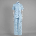 Detailed close-up of light blue floral lace fabric on short sleeve button shirt and pants - S / Blue