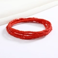 Close-up of bohemian style red layered beaded waist chain with polished glass seed beads - Red