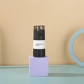Mini 150ml matte black stainless steel vacuum bottle with translucent cap on purple block - Classic Black 150ml