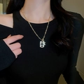 Detail of gold-plated cross pendant with sparkling rhinestones worn on a black sweater - Gold Cross Military Tag Style (6#)