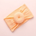 Macro shot of light orange nylon baby headband with jacquard knit donut knot detail - Light Orange