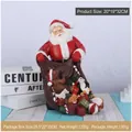 Christmas Santa Claus resin ornament carrying a gift bag with teddy bear and sweets - Santa Pouring Gifts