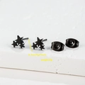 Macro shot of black triple star stud earrings measuring 0.7cm with a 2g weight - Star / Black