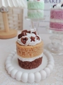 Macro detail of multi-layered strawberry and chocolate scented cake candle with sweet decor - Bicolor Cake (Sea Salt Caramel Pudding & Chocolate)
