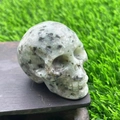 5cm hand-carved natural grey-green stone skull with black speckled texture and polished finish - Kiwi