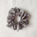 Elegant silver satin scrunchie with a glossy silk-like texture and soft folds - Dark Gray