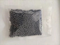 Cat litter deodorizer beads in dark grey particles shown in a transparent vacuum bag - 100g (Bag)