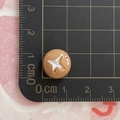 Detailed view of a 1.2cm brown miniature resin food charm with white star pattern - Mushroom