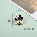 Cute cartoon bee brooch with white flower and Bee Kind text in gold finish - Nectar Gathering Bee (Bee Kind)