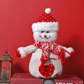 Knitted Christmas snowman doll with red polka dot hat and scarf on red background - Knitted Snowman with Heart