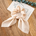Elegant cream silk scrunchie with long ribbons on a minimalist wood surface - Milky White