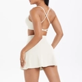 Off-white yoga set featuring a strappy sports bra and high-waisted tennis skirt - S / Light Ivory