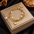 Elegant gold double-layered bracelet with a heart charm and white pearls on black silk - Gold