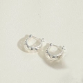 Minimalist silver C-shaped hoop earrings with star cutouts on textured white surface - Hollow Star C-Shape / Silver