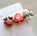 Macro shot of Christmas reindeer and snowman hair clips on a white jewelry card - Style 18 Christmas Hair Clip