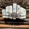 Macro shot of boho hair comb featuring raw white stones and silver triple moon emblem - White Howlite Black Wire Silver Moon