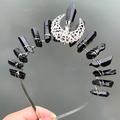 Detail of wicca crown featuring a silver moon and vertical black crystals on a silver metal base - Black