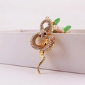 Ciondolo a forma di serpente dorato con strass scintillanti e occhi in pietra scura - Grigio/Bianco