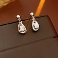 Detail of silver teardrop earrings with sparkling cubic zirconia on brown leather - Silver (S925 Silver Pin)