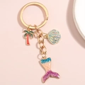 Mermaid tail keychain with palm tree and shell charms on a soft pink background - Coconut Tree Shell Mermaid Tail Style (E4997)