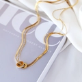 Double-layered gold titanium necklace with interlocking rings and white rhinestone accents - Double Rings / Gold