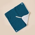 Detail of teal muslin baby bib showing soft cotton texture and white pom-pom trim - Dark Blue And White