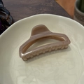 Detail of a large 10cm minimalist cream hair claw clip on a ceramic plate with wood backdrop - Deep Nude Pink