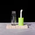 Detail of 6ml clear cosmetic tube with large sponge brush and vibrant green cap - 6ml / Green