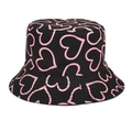 Close-up of black bucket hat featuring vibrant pink heart patterns and soft cotton fabric - Black Heart Print
