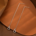 Detailed view of silver tassel earrings with water drop pendants and white zircons - Silver Zirconia