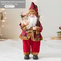 Medium red Santa Claus figurine in buffalo plaid coat with burlap gift bag and sticks - Red Medium