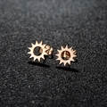 Minimalist 18K gold plated stainless steel sun stud earrings on a dark textured surface - Sun / Rose Gold