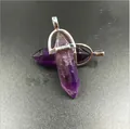 Natural purple amethyst hexagonal crystal pendant with silver metal bail on grey surface - Amethyst
