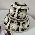 Détail d'un chapeau de paille fait main avec motifs floraux en crochet granny square - Noir