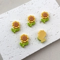 Flat lay of yellow resin sunflower charms with orange center and green leaves - 2# Yellow Sunflower