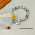 Ethnic 10mm green ghost crystal bead bracelet with silver charms and agate accents - Green Ghost: Butterfly Elephant Tassel Bracelet